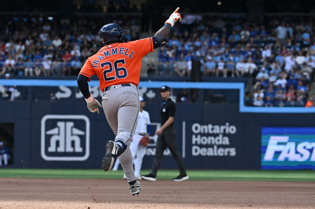 Houston Astros' Taylor Trammell (26) celebrates as he runs the bases after hitting a solo home run against the Toronto Blue Jays during the fourth inning of a baseball game in Toronto on Tuesday June 23, 2026. (Jon Blacker/The Canadian Press via AP)