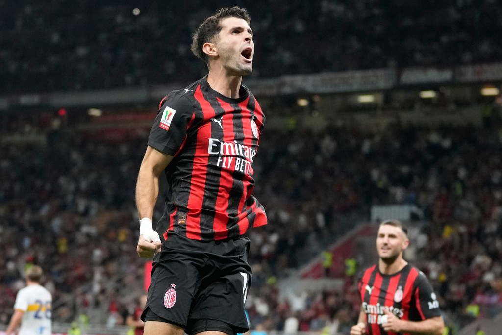 AC Milan's Christian Pulisic celebrates after scoring the third goal against Lecce, during an Italian Cup qualifying soccer match between AC Milan and Lecce, at the San Siro stadium in Milan, Italy, Tuesday, Sept. 23, 2025. (AP Photo/Luca Bruno)