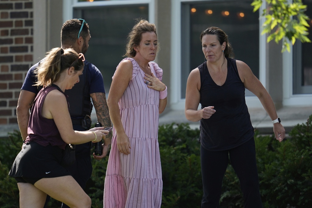 People arrive at the Annunciation Church's school as police respond to a reported mass shooting, Wednesday, Aug. 27, 2025, in Minneapolis. (AP Photo/Abbie Parr)