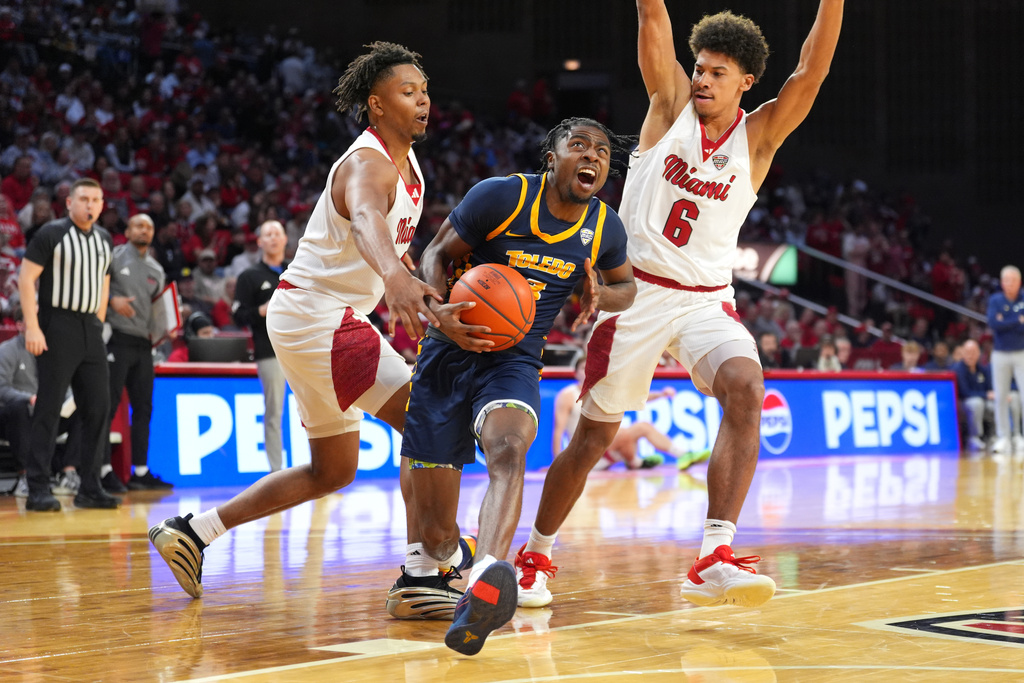 Toledo's Sonny Wilson, center, drives to the basket as Miami's (OH) Eian Elmer, and Justin Kirby, right, defend during the first half of an NCAA college basketball game, Tuesday, March 3, 2026, in Oxford, Ohio. (AP Photo/Kareem Elgazzar)