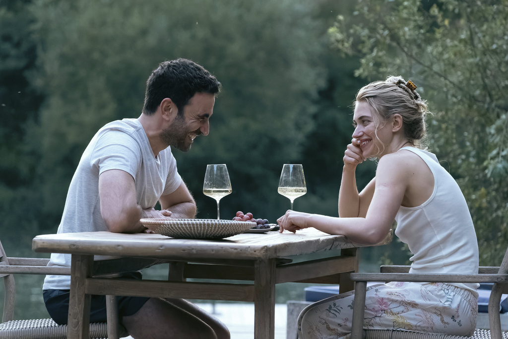 This image released by Apple TV+ shows Brett Goldstein, left, and Imogen Poots in a scene from "All of You." (Tereza Cervenova/Apple TV+ via AP)