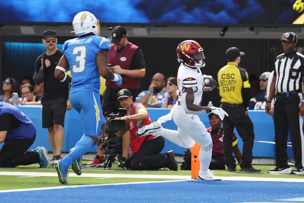 Washington Commanders running back Jacory Croskey-Merritt (22) scores a rushing touchdown during the first half of an NFL football game against the Los Angeles Chargers, Sunday, Oct. 5, 2025, in Inglewood, Calif. (AP Photo/Eric Thayer)