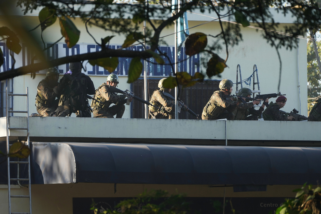 Security forces enter the Renovation maximum-security prison to free guards taken hostage and retake control of the facility, which houses gang leaders, in Escuintla, Guatemala, Sunday, Jan. 18, 2026. (AP Photo/Moises Castillo)