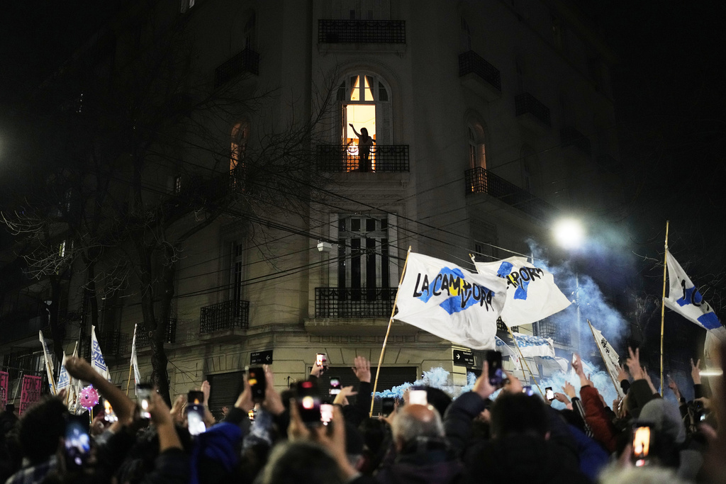 Former President Cristina Fernandez waves to supporters from the balcony of her home where she is serving a six-year house arrest sentence for corruption, after legislative provincial election polls closed, in Buenos Aires, Argentina, Sunday, Sept. 7, 2025. (AP Photo/Natacha Pisarenko)