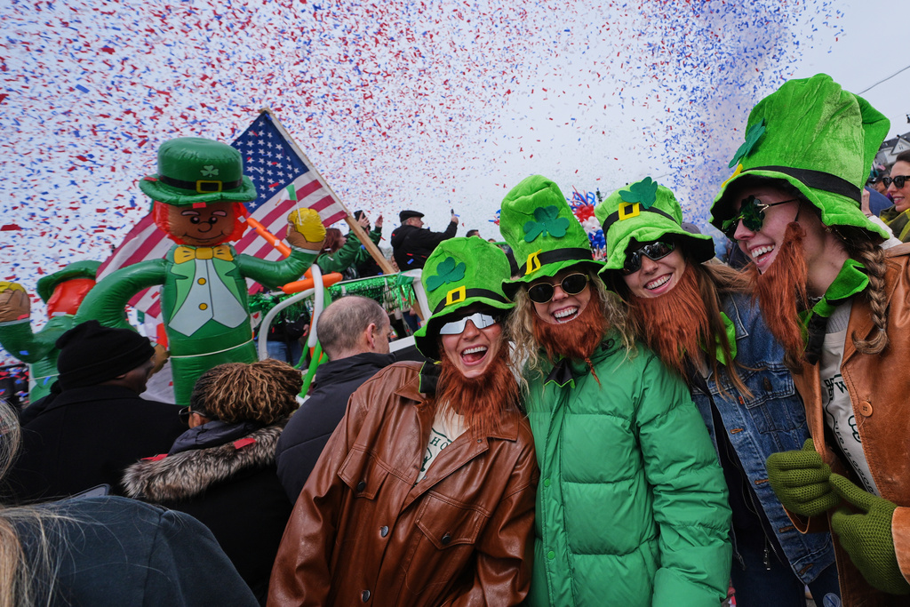 Women wearing leprechaun hats and beards smile as confetti cannons blast during the annual St. Patrick's Day parade through the South Boston neighborhood, Sunday, March 15, 2026, in Boston. (AP Photo/Charles Krupa)