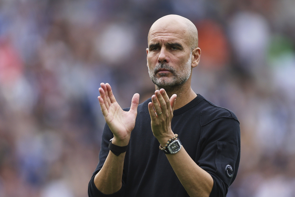 Manchester City's head coach Pep Guardiola applauds supporters after the English Premier League soccer match between Brighton and Hove Albion and Manchester City at the Falmer stadium in Brighton, England, Sunday, Aug. 31, 2025. (AP Photo/Ian Walton)