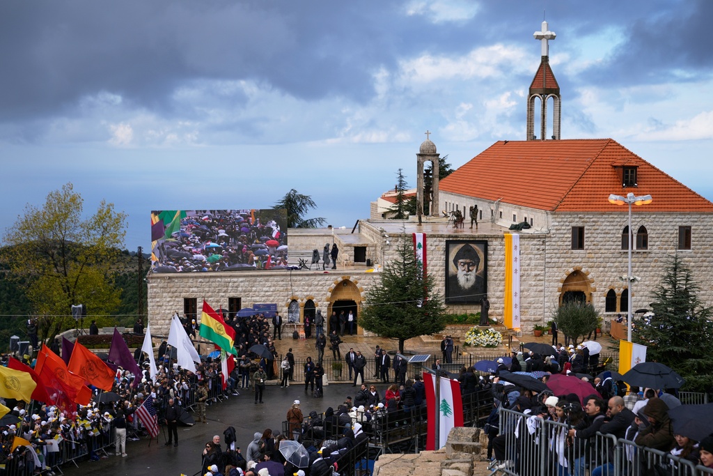 People wait outside the Monastery of Saint Maroun ahead of Pope Leo XIV's arrival in Annaya, Lebanon, Monday, Dec. 1, 2025. (AP Photo/Hassan Ammar)