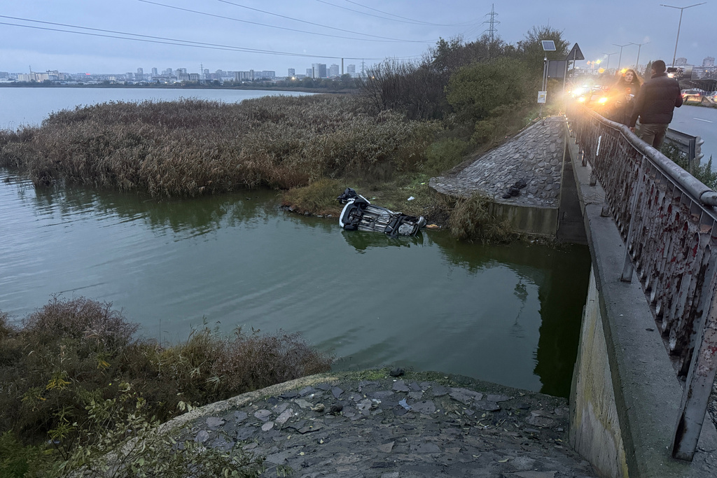 A crashed vehicle is seen out of a road after a police chase near Burgas, Bulgaria, Friday 7 Nov. 2025. (NOVA TV Bulgaria via AP)