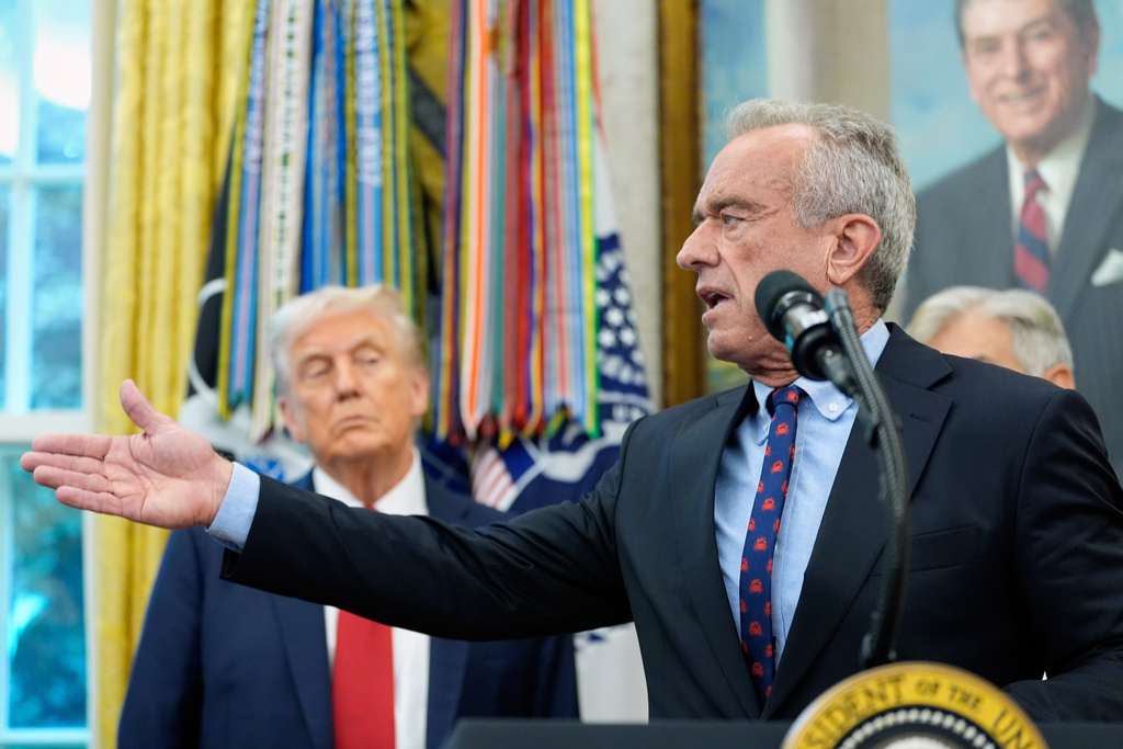 FILE - Secretary of Health and Human Services Robert F. Kennedy Jr. speaks in the Oval Office of the White House, Tuesday, Sept. 30, 2025, in Washington, as President Donald Trump looks on. (AP Photo/Alex Brandon, File) (AP Photo/Alex Brandon, File)