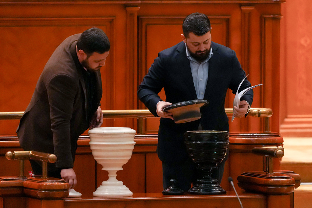 Staff members check the voting urns ahead of a no confidence vote against Prime Minister Ilie Bolojan's government in Bucharest, Romania, Tuesday, May 5, 2026. (AP Photo/Vadim Ghirda)