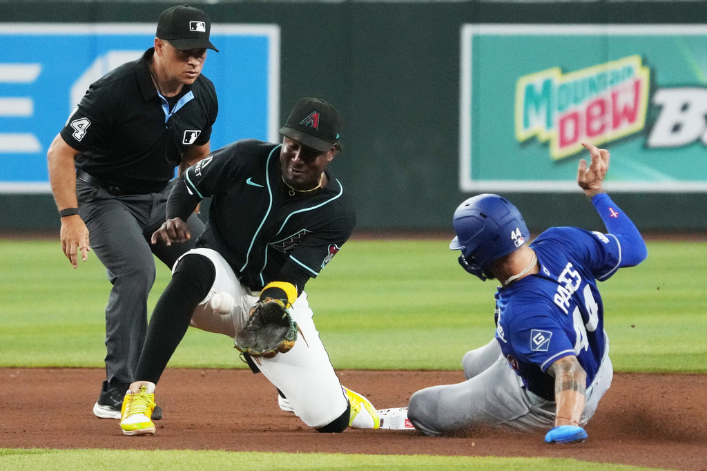 Los Angeles Dodgers' Andy Pages (44) steals second base under the tag by Arizona Diamondbacks shortstop Geraldo Perdomo in the seventh inning of a baseball game, Saturday, Aug 8, 2026, in Phoenix. (AP Photo/Rick Scuteri)