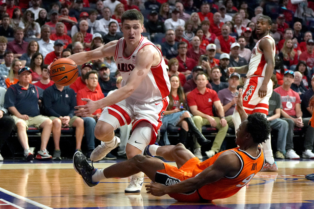 Arizona forward Ivan Kharchenkov, left, gets fouled by Oklahoma State guard Anthony Roy (9) during the second half of an NCAA college basketball game, Saturday, Feb. 7, 2026, in Tucson, Ariz. (AP Photo/Rick Scuteri)