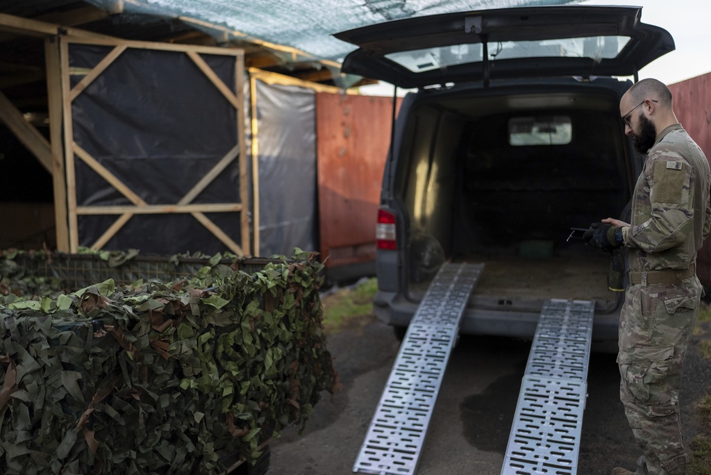 A Ukrainian serviceman known by call sign "Demis" loads a drone onto a car near the front line in Donetsk region, Ukraine, on Monday, Sept. 8, 2025. (AP Photo/Alex Babenko)