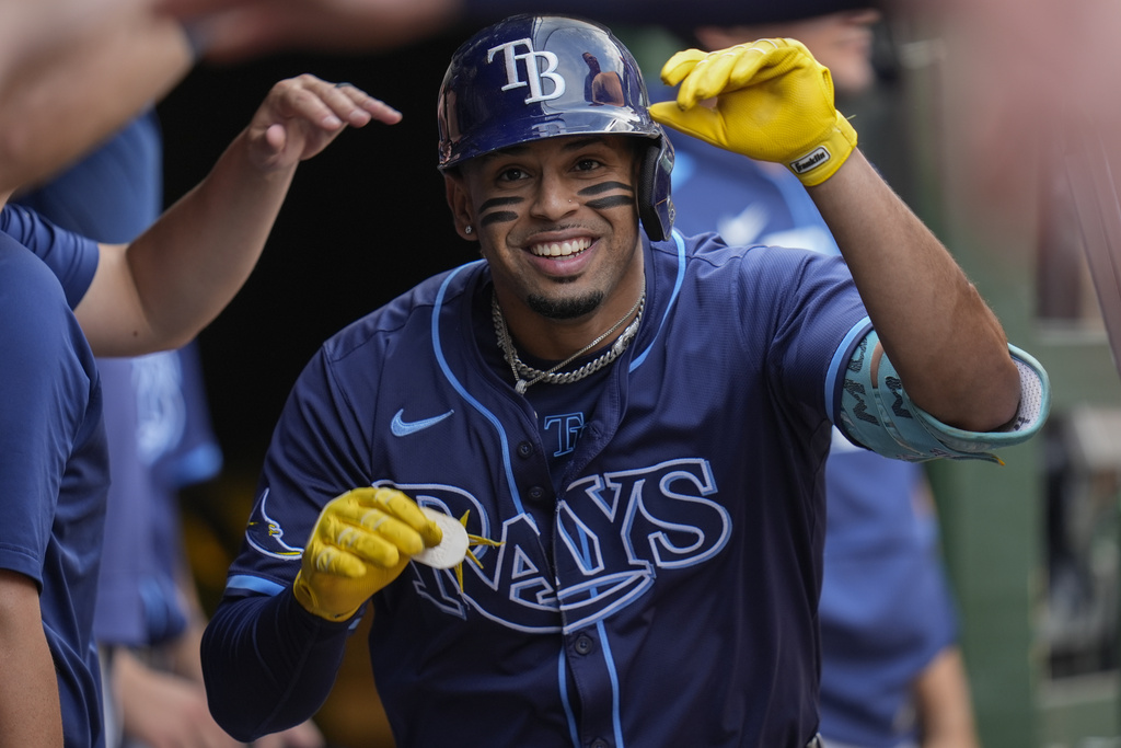 Tampa Bay Rays designated hitter Christopher Morel (24) celebrates in the dugout after hitting a three-run home run during the first inning of a baseball game against the Chicago Cubs, Friday, Sept. 12, 2025, in Chicago. (AP Photo/Erin Hooley)