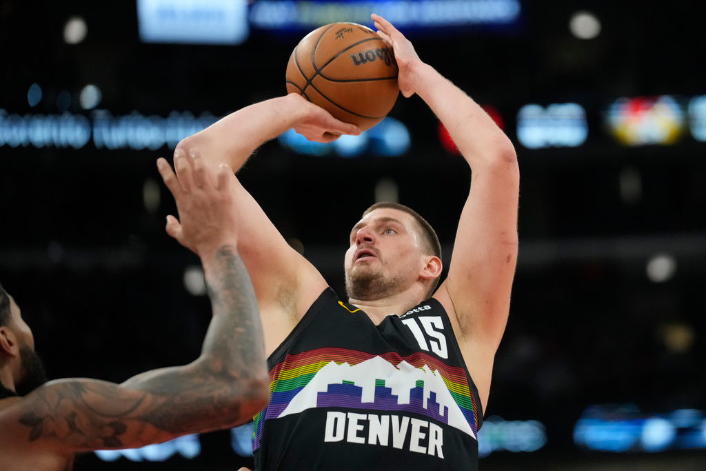 Denver Nuggets center Nikola Jokic (15), right, handles the ball as Chicago Bulls center Nick Richards (13) defends during the second half of an NBA basketball game Saturday, Feb. 7, 2026, in Chicago. (AP Photo/Erin Hooley)