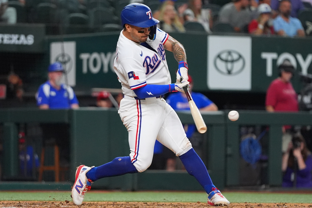 Texas Rangers' Cody Freeman hits a run scoring single during the third inning of a baseball game against the Washington Nationals, Tuesday, Aug. 18, 2026, in Arlington, Texas. (AP Photo/LM Otero)