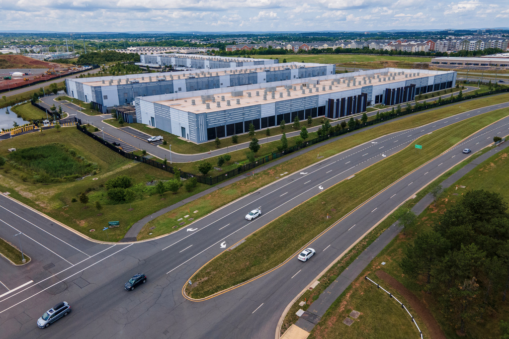 FILE - Cars drive past data centers, July 16, 2023, in Ashburn, Va. (AP Photo/Ted Shaffrey, File)