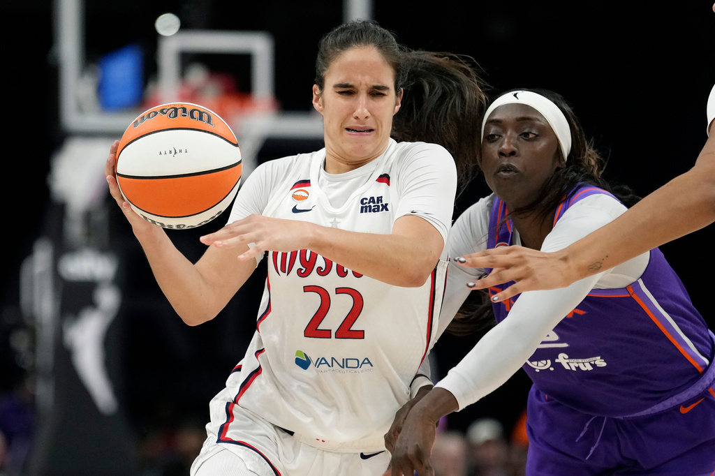 Washington Mystics guard Sonia Citron (22) tries to drive past Phoenix Mercury guard-forward Kahleah Copper during the second half of a WNBA basketball game, Thursday, Aug. 27, 2026, in Phoenix. (AP Photo/Ross D. Franklin)
