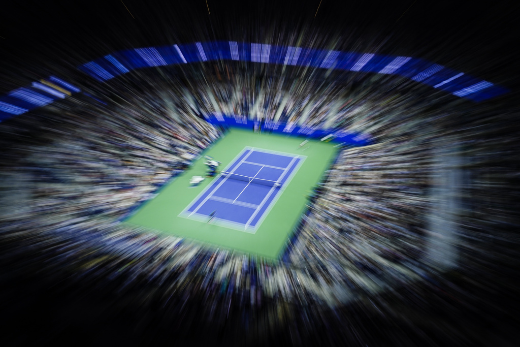 FILE - In this image made with a zoom lens and slow shutter speed, Frances Tiafoe, near side, of the United States, plays against Sebastian Ofner, of Austria, during the second round of the U.S. Open tennis tournament Wednesday, Aug. 30, 2023, at Arthur Ashe Stadium in New York. (AP Photo/Frank Franklin II, file)