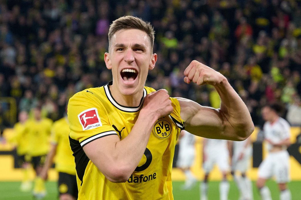 Borussia Dortmund's Nico Schlotterbeck celebrates scoring a goal during a Bundesliga soccer match between Borussia Dortmund and Eintracht Frankfurt, Friday, May 8, 2026, in Dortmund, Germany. (Bernd Thissen/dpa via AP)