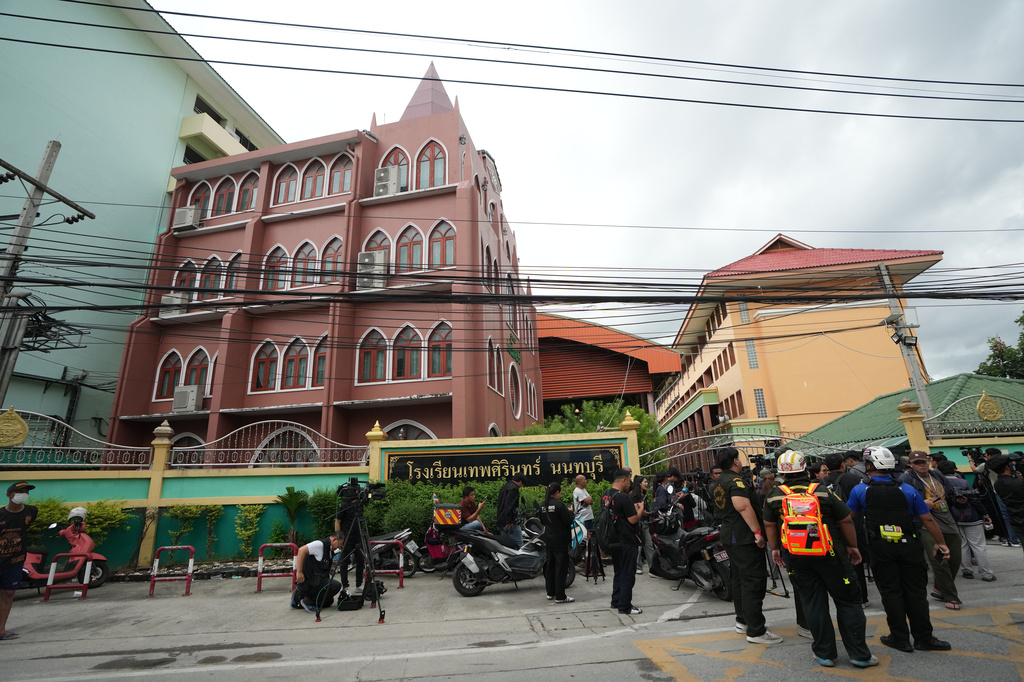 People gather outside after a shooting at the Debsirin Nonthaburi School in Thailand's Nonthaburi province, Friday, Aug. 7, 2026. (AP Photo/Sakchai Lalit)