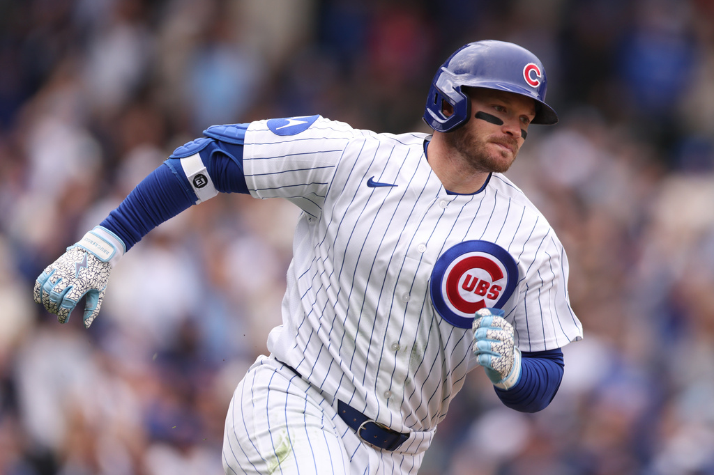Chicago Cubs Ian Happ (8) rounds the bases after hitting a solo home run during the fourth inning of a baseball game against the Washington Nationals at Wrigley Field on Sunday, March 29, 2026, in Chicago. (AP Photo/Geoff Stellfox)