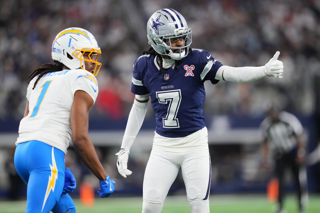 Dallas Cowboys cornerback Trevon Diggs (7) defends on Los Angeles Chargers wide receiver Quentin Johnston (1) during the first half of an NFL football game Sunday, Dec. 21, 2025, in Arlington, Texas. (AP Photo/Julio Cortez)
