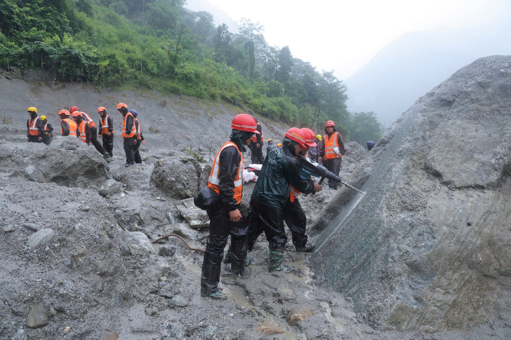 This photo provided by the Nepal Army, shows Nepal army soldiers using a drilling machine during a rescue operation at the site of a hydropower project in Upper Trishuli, Nepal, Sunday, Aug. 30, 2026. (Nepal Army via AP)