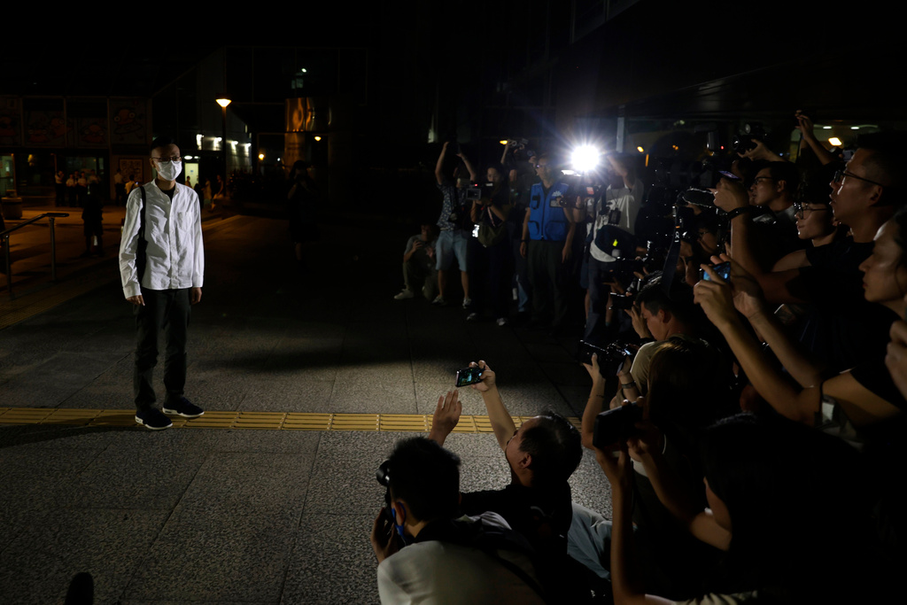 FILE- Patrick Lam, the former acting editor-in-chief of Hong Kong's now shuttered pro-democracy news outlet Stand News stands before the gathered media as he leaves the Wanchai District Court after the final sentencing in Wan Chai district court, in Hong Kong on Sept. 26, 2024. (AP Photo/May James, File)