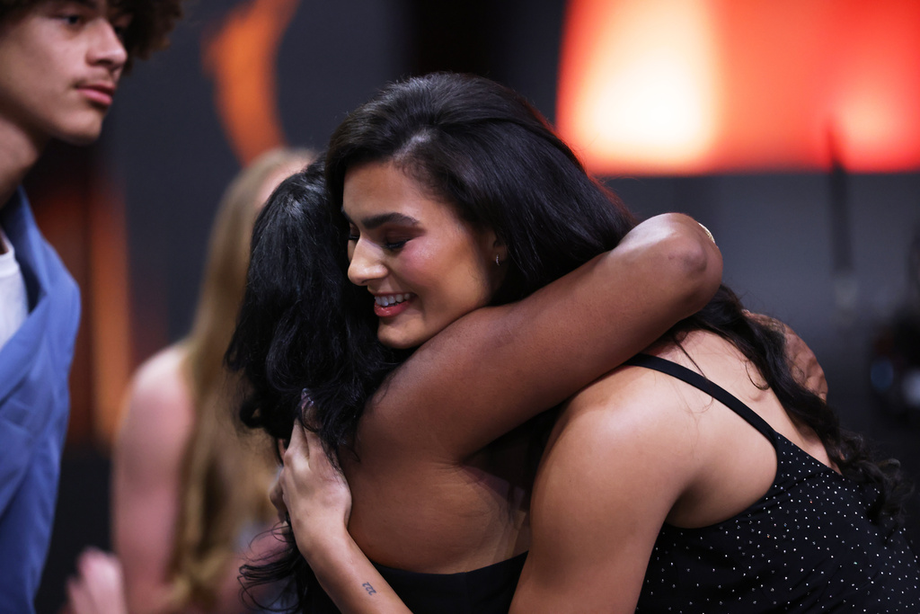 UCLA center Lauren Betts hugs her mother Michelle after being selected fourth overall by the Washington Mystics in the first round of the WNBA basketball draft Monday, April 13, 2026, in New York. (AP Photo/Pamela Smith)