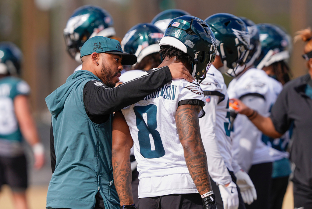 FILE - Philadelphia Eagles secondary coach Christian Parker talks with safety C.J. Gardner-Johnson (8) during an NFL football practice, Feb. 5, 2025, in New Orleans. (AP Photo/Gerald Herbert, File)