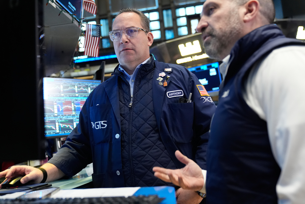 Anthony Matesic, left, and James Denaro work on the floor at the New York Stock Exchange in New York, Thursday, March 19, 2026. (AP Photo/Seth Wenig)