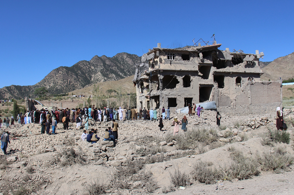 Residents walk through the rubble after what Taliban officials said were Pakistani airstrikes a day earlier that killed civilians, including children, in the village of Mandokhail, Chamkani district, Paktia province, Afghanistan, Monday, June 29, 2026. (AP Photo/Saifullah Zahir)