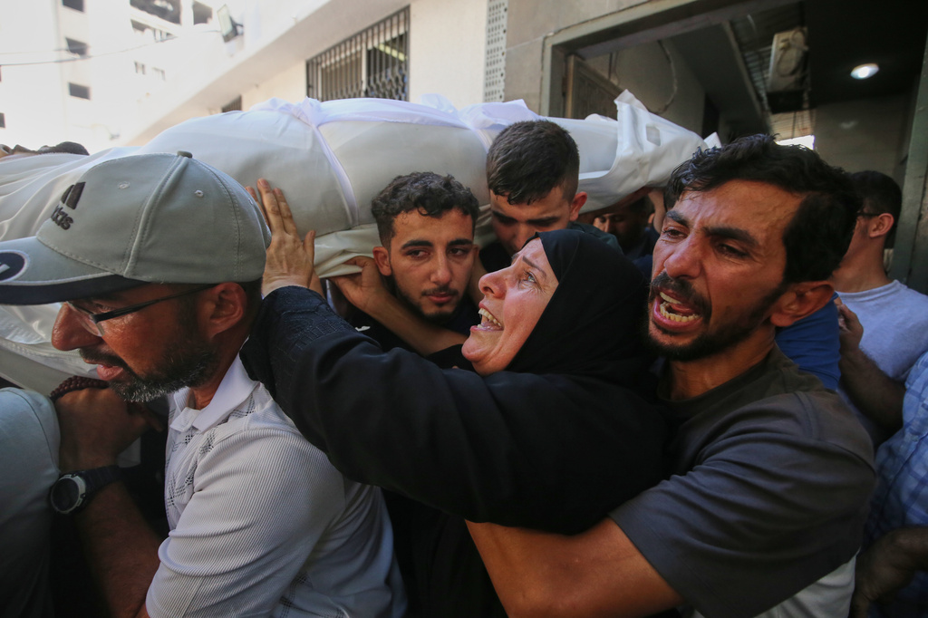 Mourners carry the body of Palestinian Bassir al Barsh, who was killed in an Israeli airstrike, during his funeral at a hospital in Gaza city, Saturday, Sept. 19, 2026. (AP Photo/Yousef Al Zanoun)