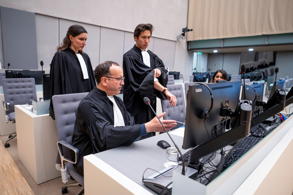 Defense attorney Nicholas Kaufman, seated, waits for the International Criminal Court (ICC) to rule on a request to release former Philippine President Rodrigo Duterte, in The Hague, Netherlands, Friday, Nov. 28, 2025. (Lina Selg/Pool Photo via AP)