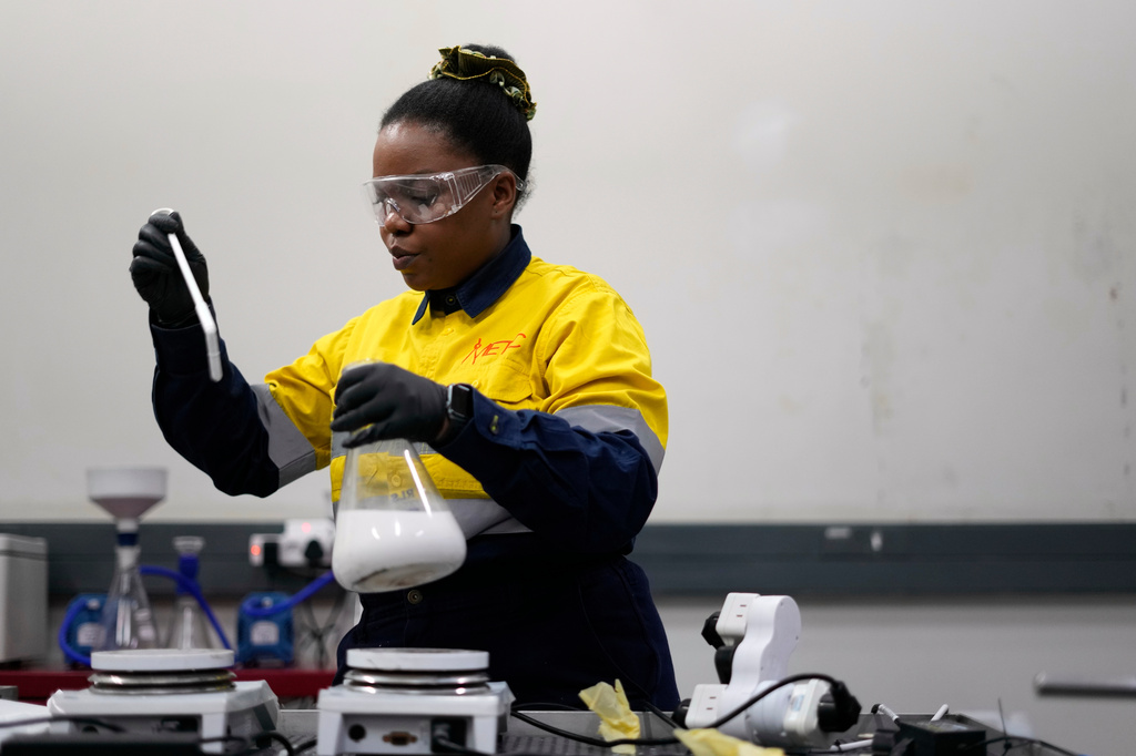 Mamasia Moshokwa, a junior process engineer, inspects an ongoing leaching test, in Johannesburg, South Africa, Thursday, Aug. 7, 2025. (AP Photo/Themba Hadebe)