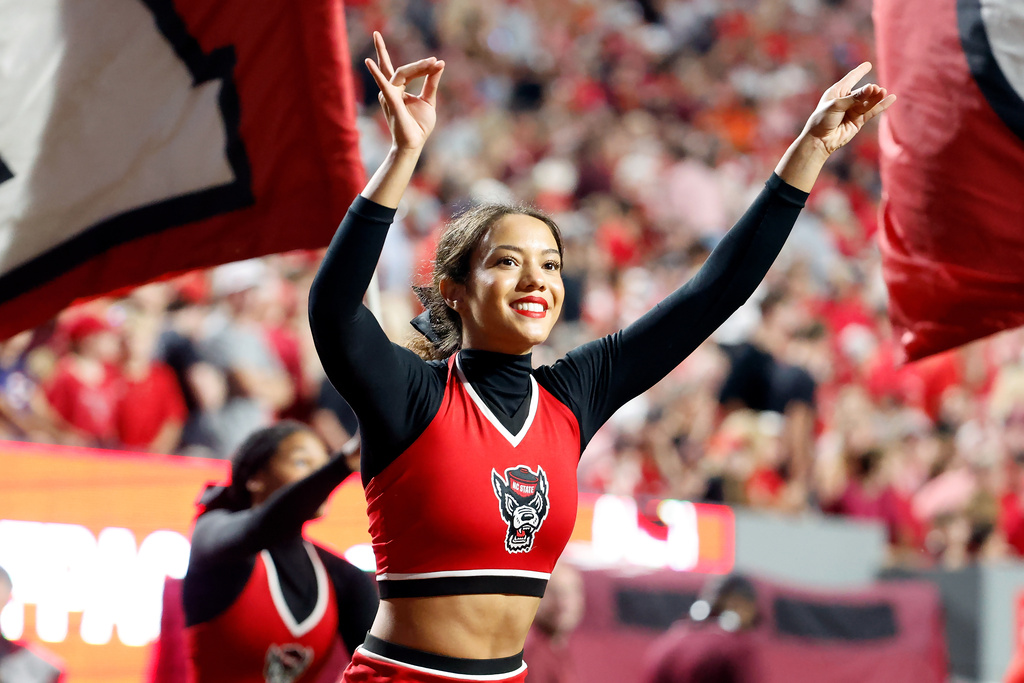 A North Carolina State cheerleader celebrates an touchdown against Virginia Tech during the first half of an NCAA college football game in Raleigh, N.C., Saturday, Sept. 27, 2025. (AP Photo/Karl DeBlaker)