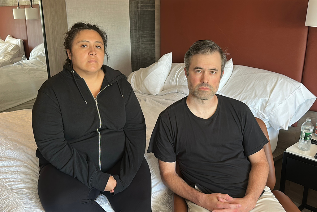Mark Bray, a Rutgers assistant professor of history, and his wife, Yesenia Barragan, a Rutgers associate professor of history, wait in their hotel room in Newark, N.J., before a planned flight to Spain on Thursday, Oct. 9, 2025. (AP Photo/Ted Shaffrey)