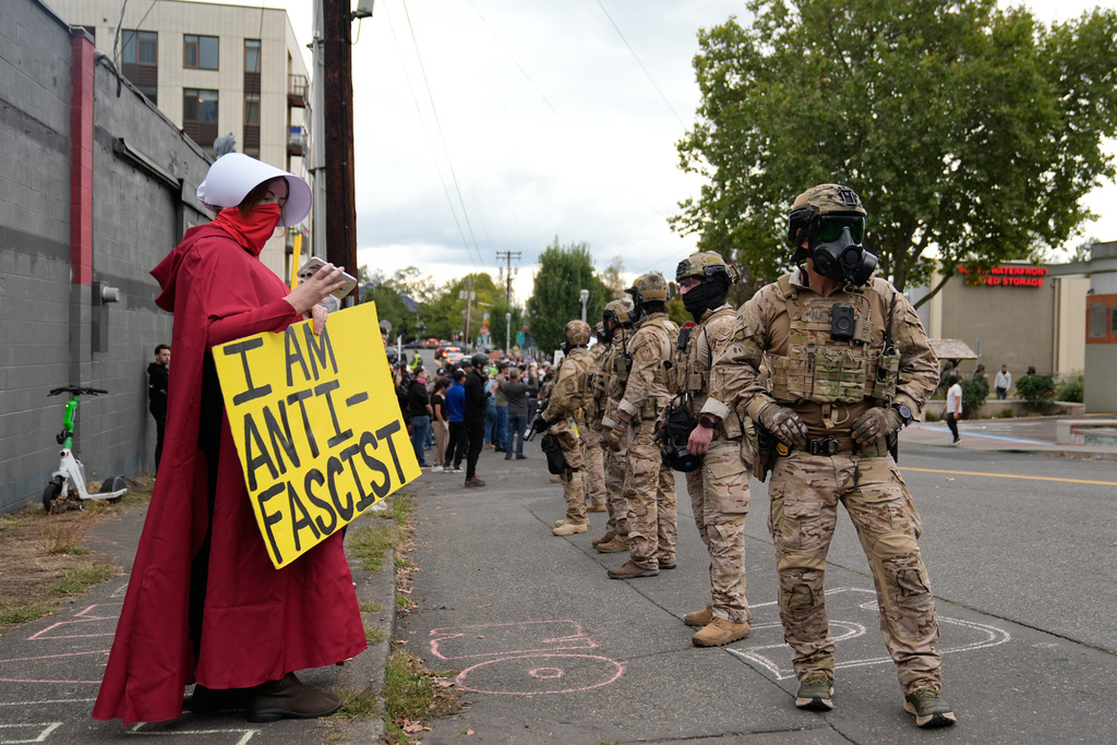 Customs and Border Protection agents standoff against demonstrators outside a U.S. Immigration and Customs Enforcement facility during a protest on Saturday, Oct. 4, 2025, in Portland, Ore. (AP Photo/Jenny Kane)