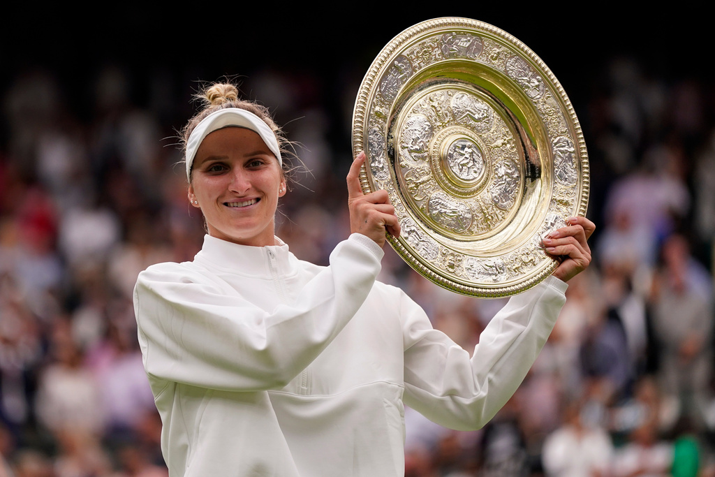 FILE - Czech Republic's Marketa Vondrousova celebrates with the trophy after beating Tunisia's Ons Jabeur to win the final of the women's singles on day thirteen of the Wimbledon tennis championships in London, Saturday, July 15, 2023. (AP Photo/Alberto Pezzali, file)