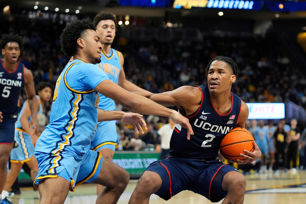 UConn's Silas Demary Jr. drives to the basket against Marquette's Adrien Stevens during the second half of an NCAA college basketball game Saturday, March 7, 2026, in Milwaukee. (AP Photo/Aaron Gash)