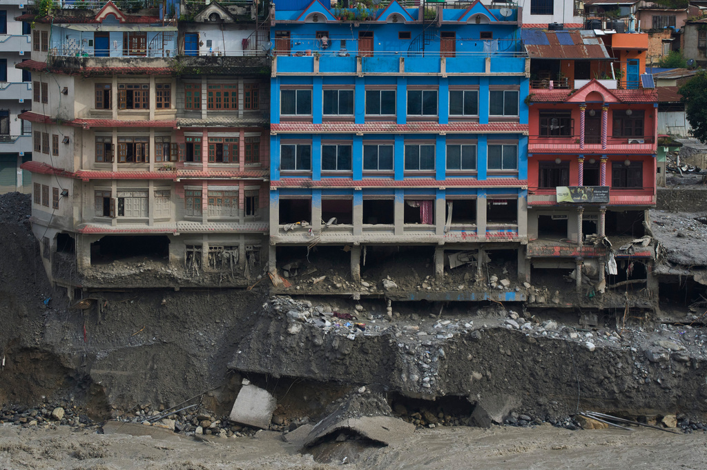Houses damaged by flash floods are seen on the bank of Trishuli river in Dhunge, Nuwakot district, Nepal, Monday, Sept. 7, 2026. (AP Photo/Niranjan Shrestha)