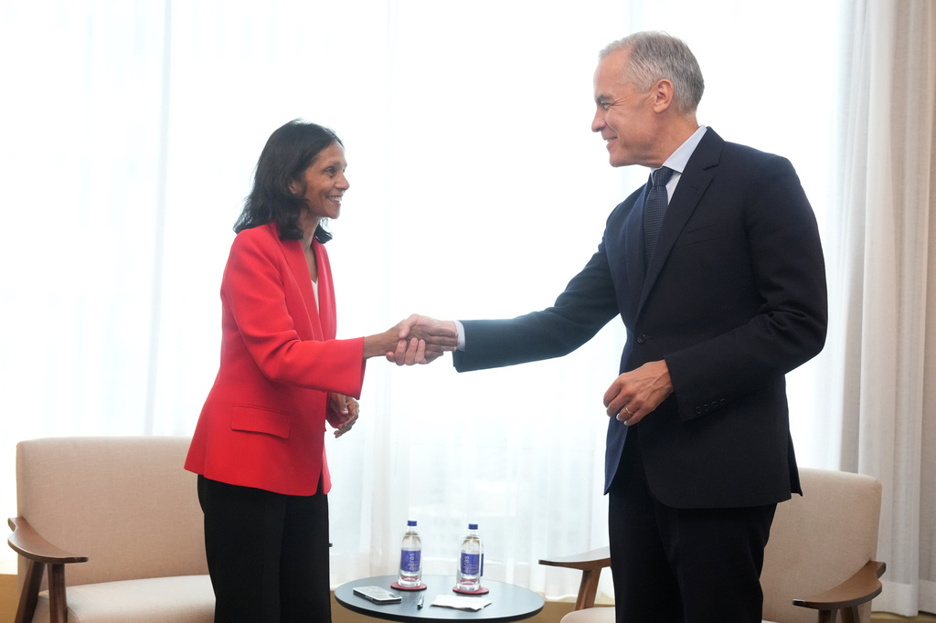 Canada Prime Minister Mark Carney, right, meets with the Managing Director and Chief Executive Officer of Macquarie Group Shemara Wikramanayake in Toronto on Monday, Sept. 14, 2026. (Nathan Denette/The Canadian Press via AP)