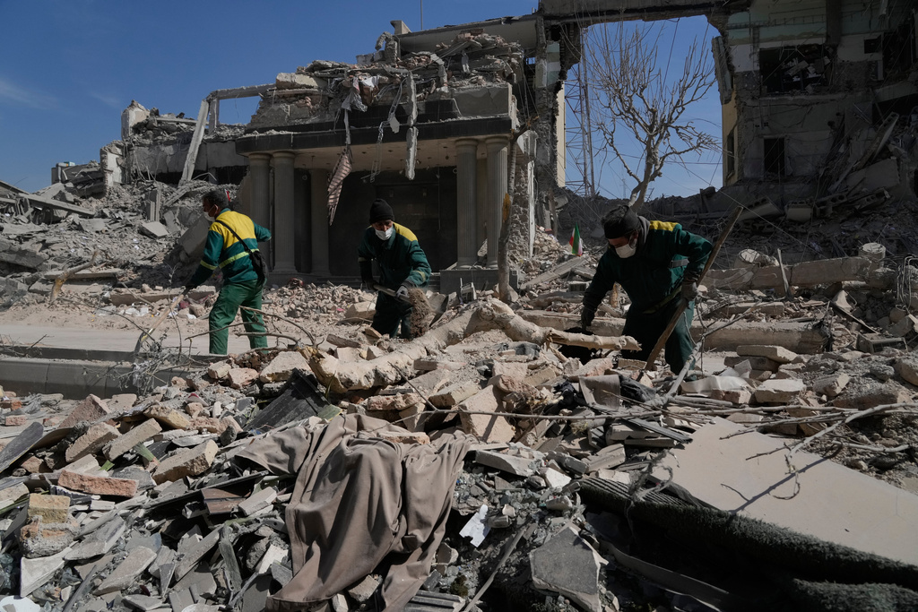 Workers remove the rubble of a police facility struck during the U.S.–Israeli military campaign in Tehran, Iran, Wednesday, March 4, 2026. (AP Photo/Vahid Salemi)