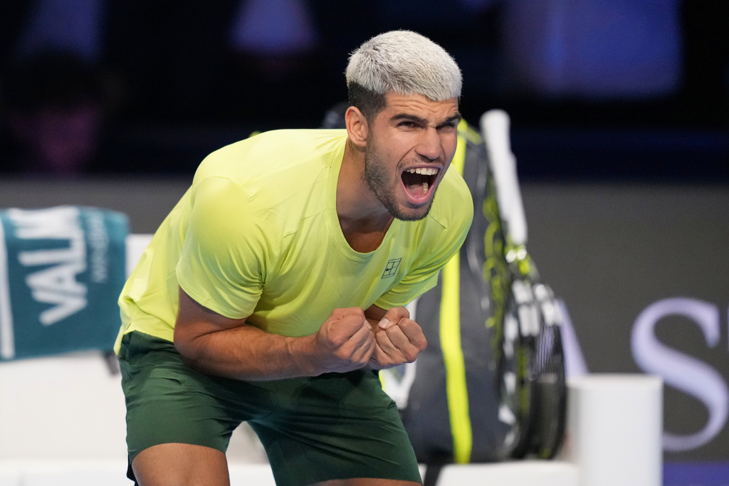 Spain's Carlos Alcaraz celebrates after winning against Italy's Lorenzo Musetti during the tennis match of the ATP World Tour Finals, in Turin, Italy, Thursday, Nov. 13, 2025. (AP Photo/Antonio Calanni)