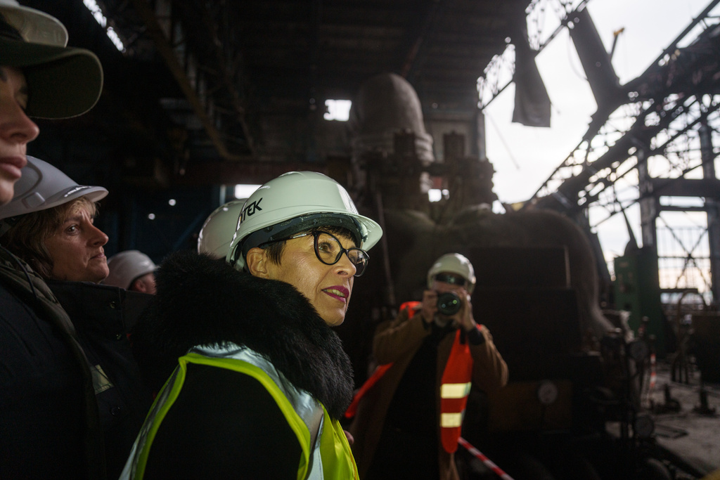 EU Commissioner for Enlargement Marta Kos looks at a production hall damaged after a recent Russian missile attack at DTEK's power plant in Ukraine, on Wednesday, Dec. 10, 2025. (AP Photo/Evgeniy Maloletka)