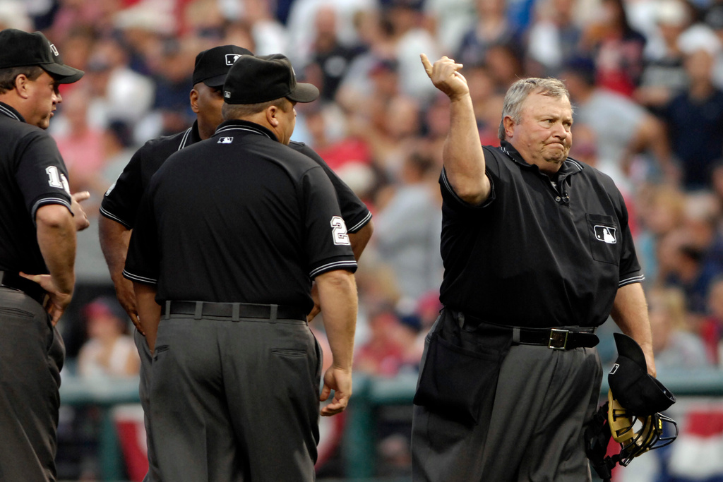 FILE - Umpire Bruce Froemming, right, signals a home run for New York Yankees' Johnny Damon after conferring with his crew during the first inning of Game 1 of an American League Division Series baseball game against the Cleveland Indians, Oct. 4, 2007, in Cleveland. (AP Photo/Ken Blaze, File)