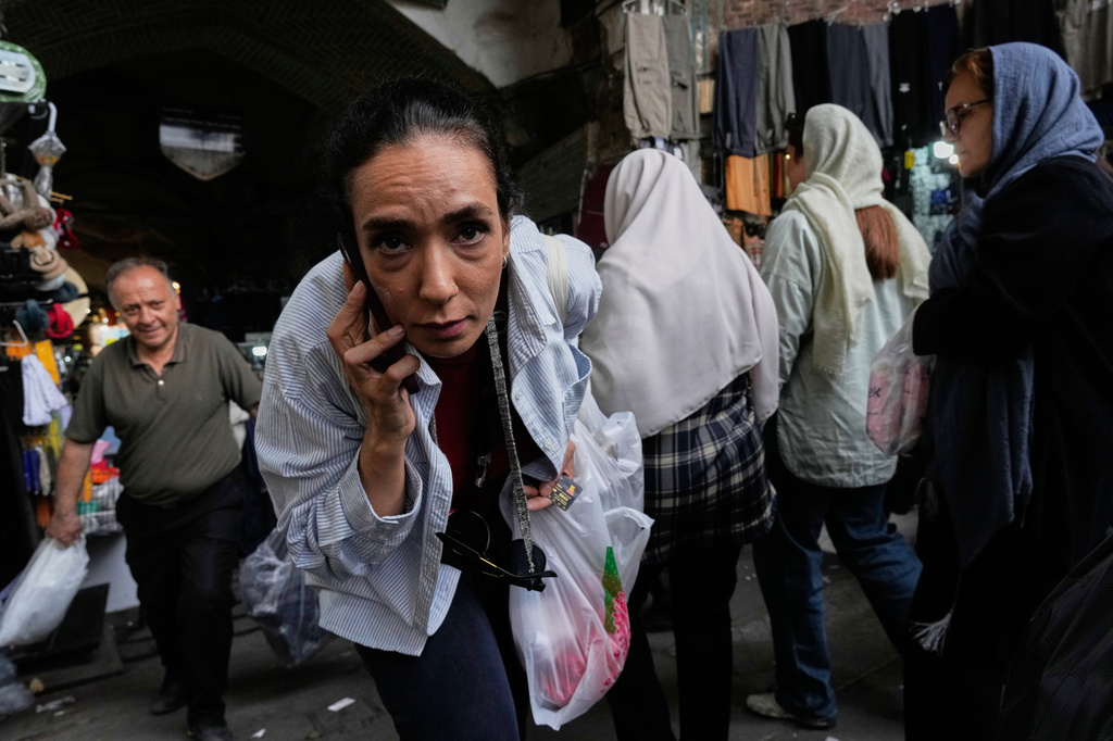 A woman reacts to the camera at Tehran's historic Grand Bazaar, Iran, Sunday, May 3, 2026. (AP Photo/Vahid Salemi)