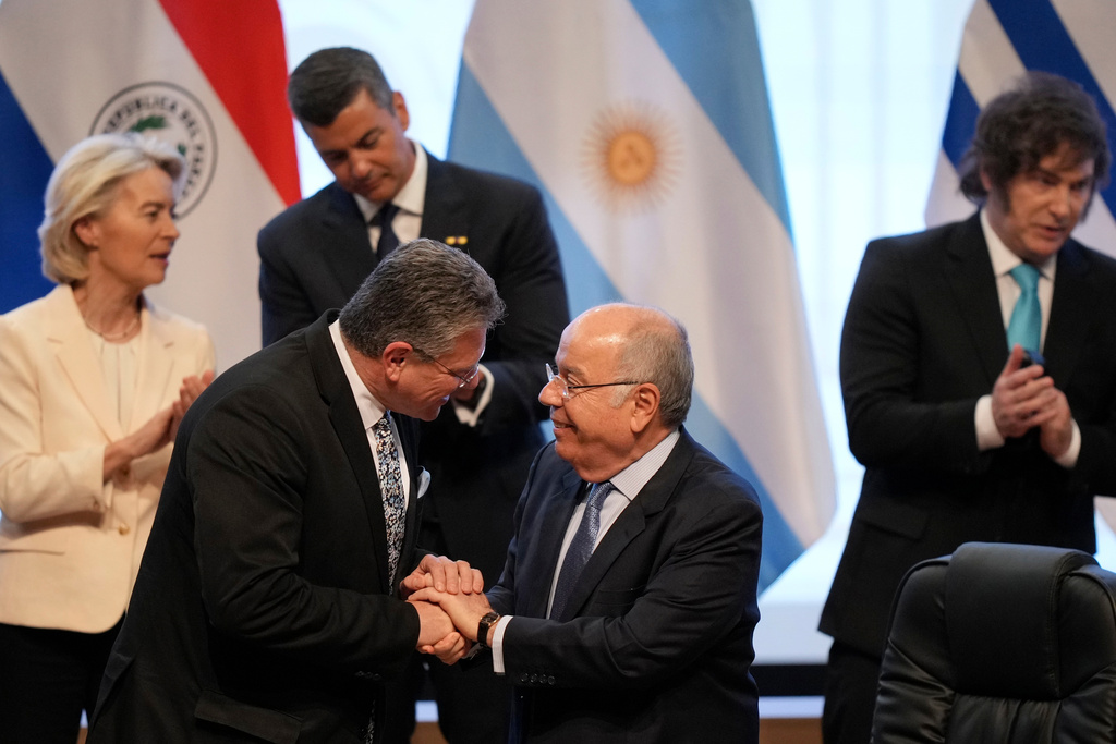 Economic Security Maros Sefcovic, left front, and Brazilian Minister of Foreign Affairs Mauro Vieira greet each other during a meeting to sign a free trade deal between the European Union and Mercosur in Asuncion, Paraguay, Saturday, Jan. 17, 2026. (AP Photo/Jorge Saenz)