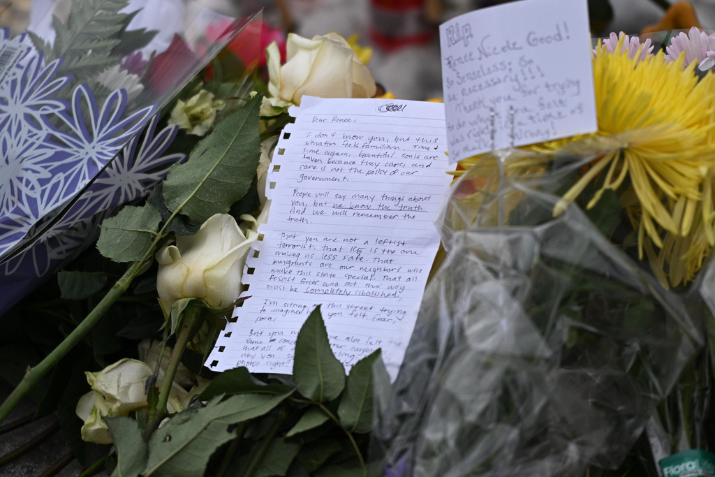 Notes and flowers are placed at a makeshift memorial honoring the victim of a fatal shooting involving federal law enforcement agents, near the site of the shooting, Thursday, Jan. 8, 2026, in Minneapolis. (AP Photo/Tom Baker)
